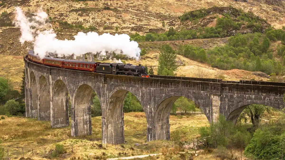 The Jacobite steam train, used as the Hogwarts Express, crossing the Glenfinnan Viaduct on a Glenfinnan Viaduct steam train tour