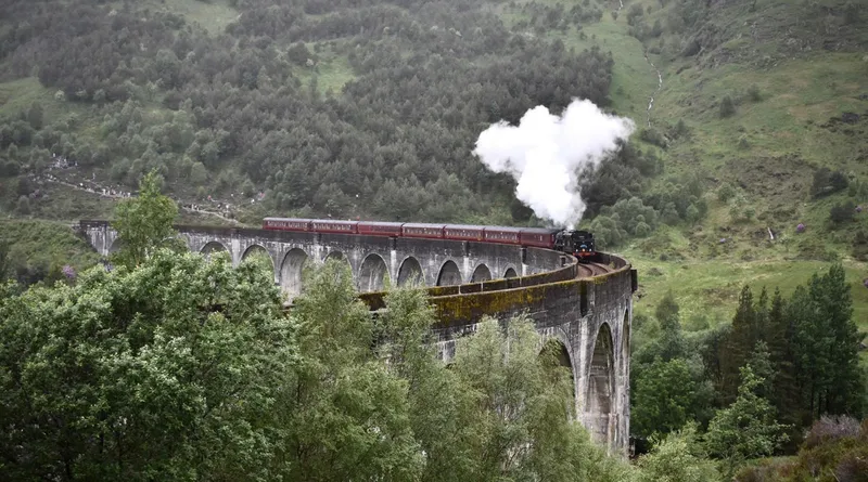 The 21-arch Glenfinnan Viaduct curving above Loch Shiel on a Glenfinnan Viaduct tour from Edinburgh, Scottish Highlands