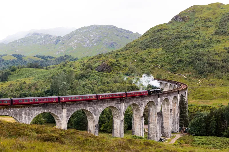 The Jacobite Steam Train, the Hogwarts Express, crossing the Glenfinnan Viaduct on a Glenfinnan Viaduct steam train tour from Edinburgh, Scotland
