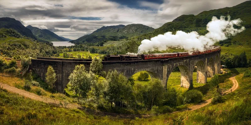 Glenfinnan Viaduct and the calm waters of Loch Lomond on a Glenfinnan and Loch Lomond tour from Glasgow, Scottish Highlands